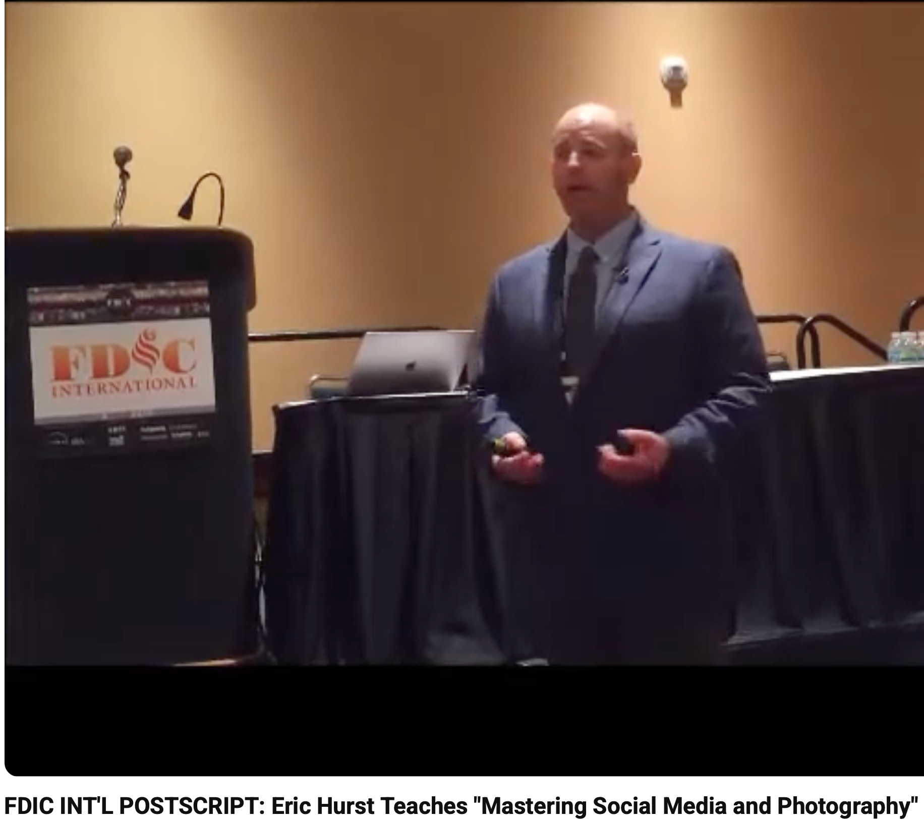 Eric Hurst presenting beside an FDIC International podium